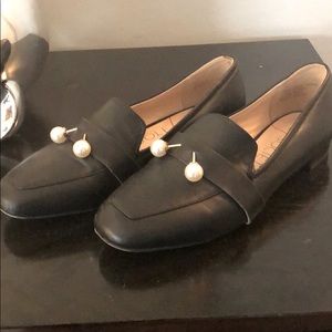 Black loafer/flat with white pearl detail.
